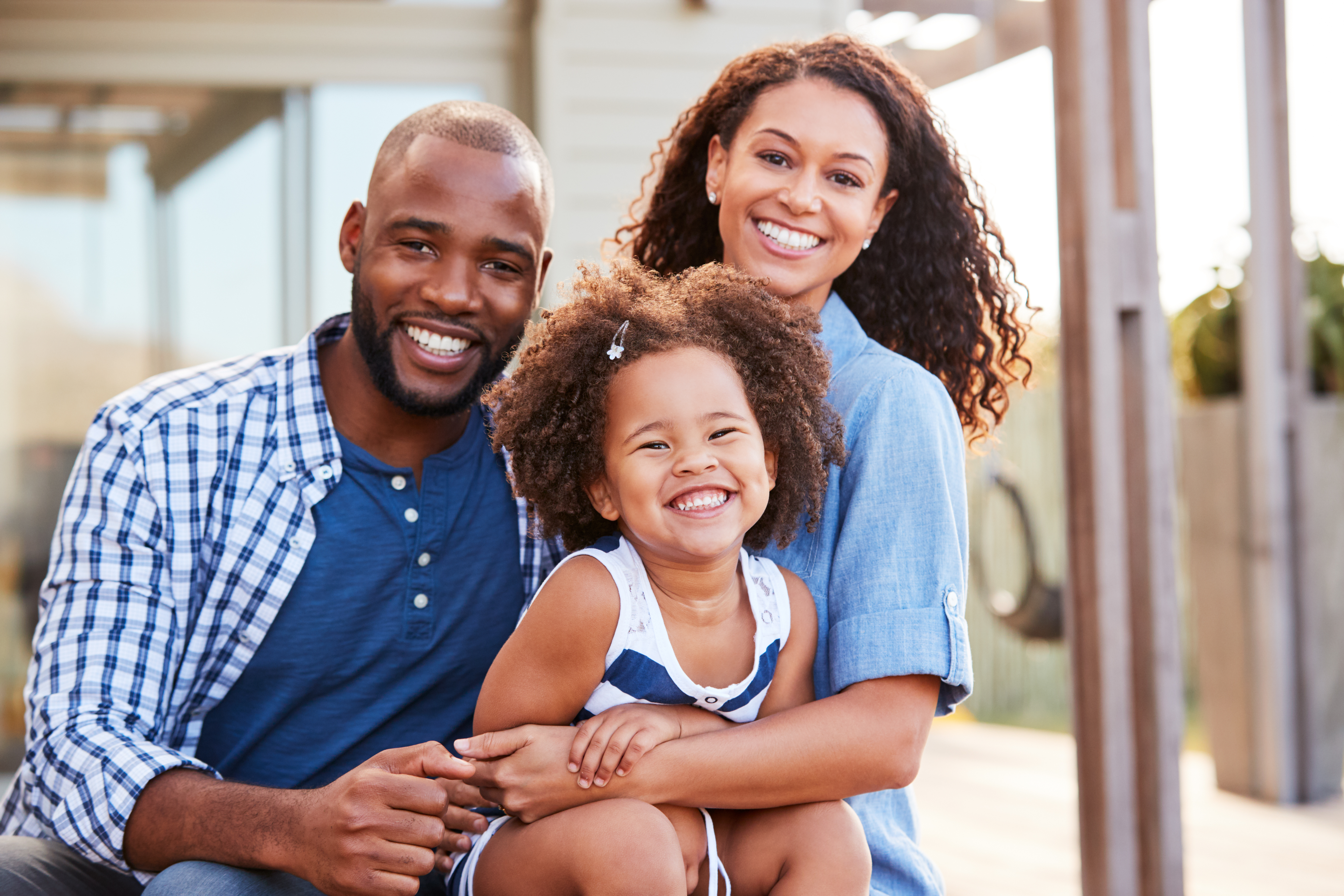 Young Black Family Embracing